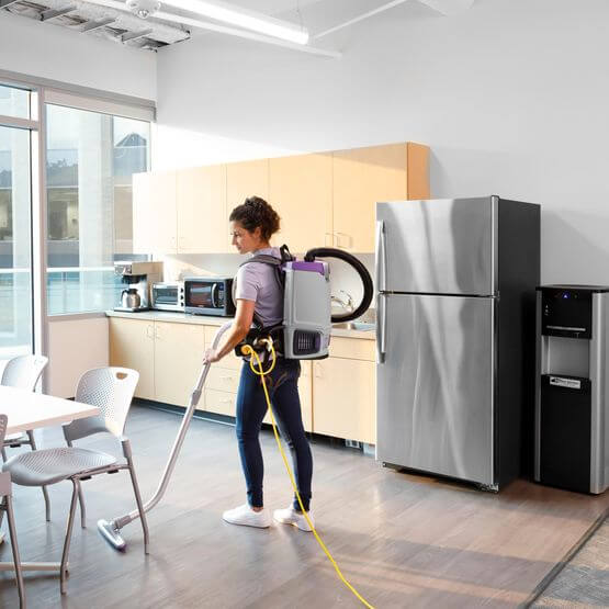 woman vacuuming kitchen with gofit 6 backpack vacuum proteam